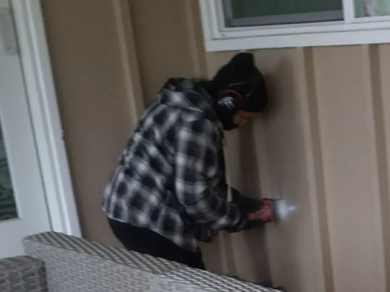 Professional electrician installing an exterior outlet in Oakfield